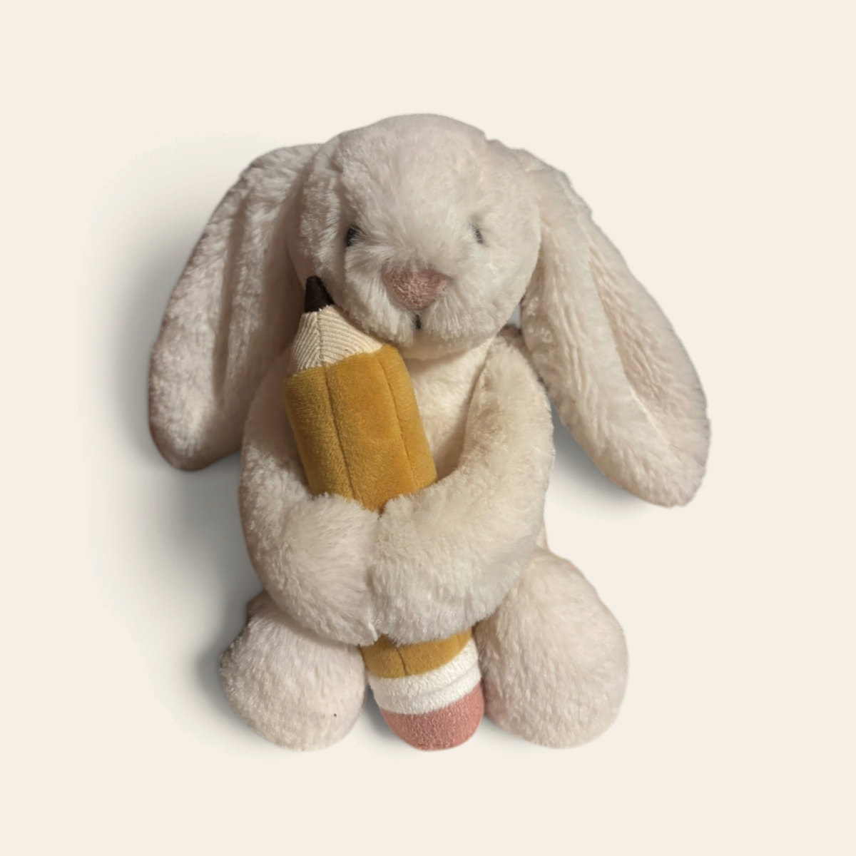 Bashful Bunny with Pencil BB6PEN: a cream plush bunny with long floppy ears holding a striped plush pencil