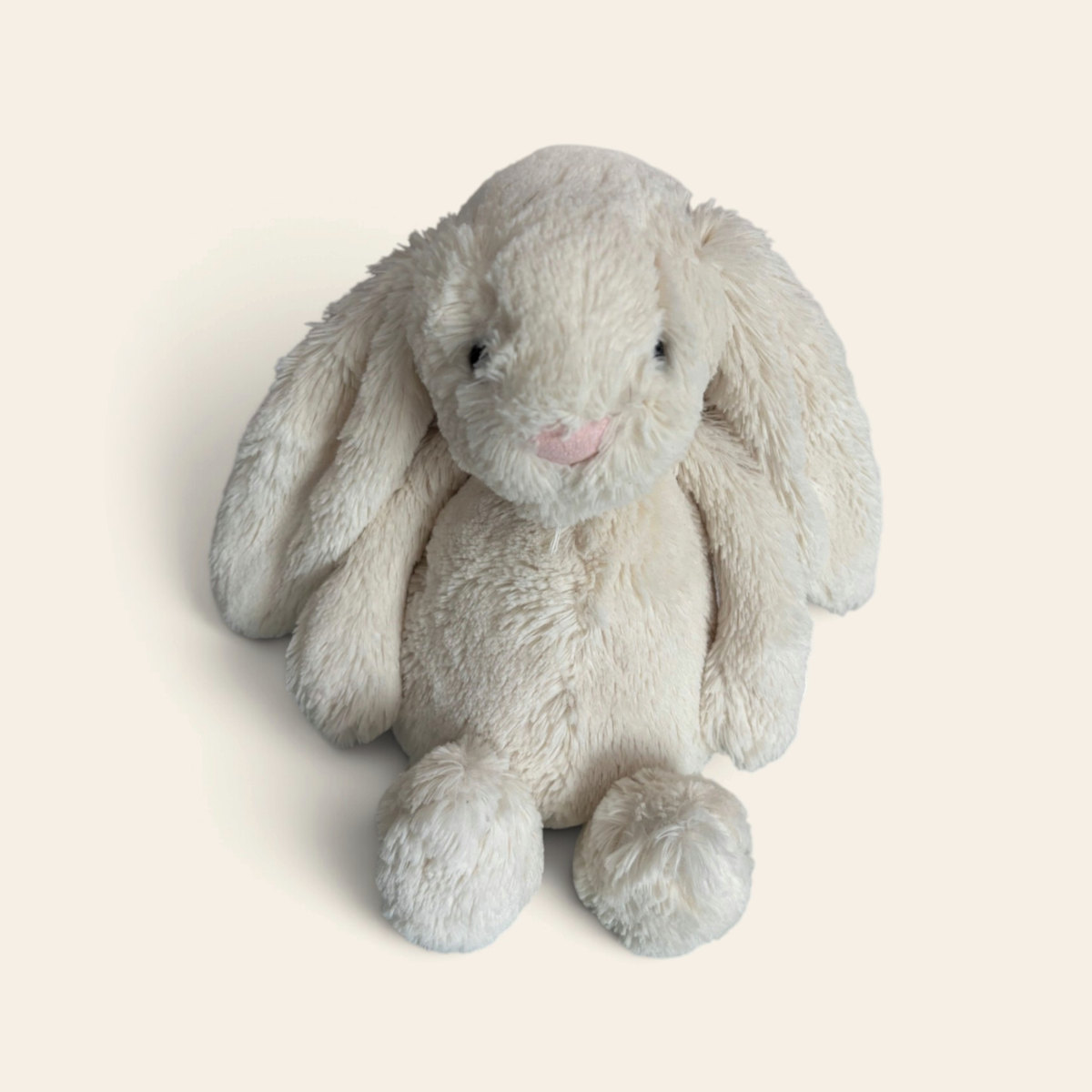 Bashful Cream Bunny BAS3BC: a cream plush bunny with long floppy ears and a pink nose, sitting