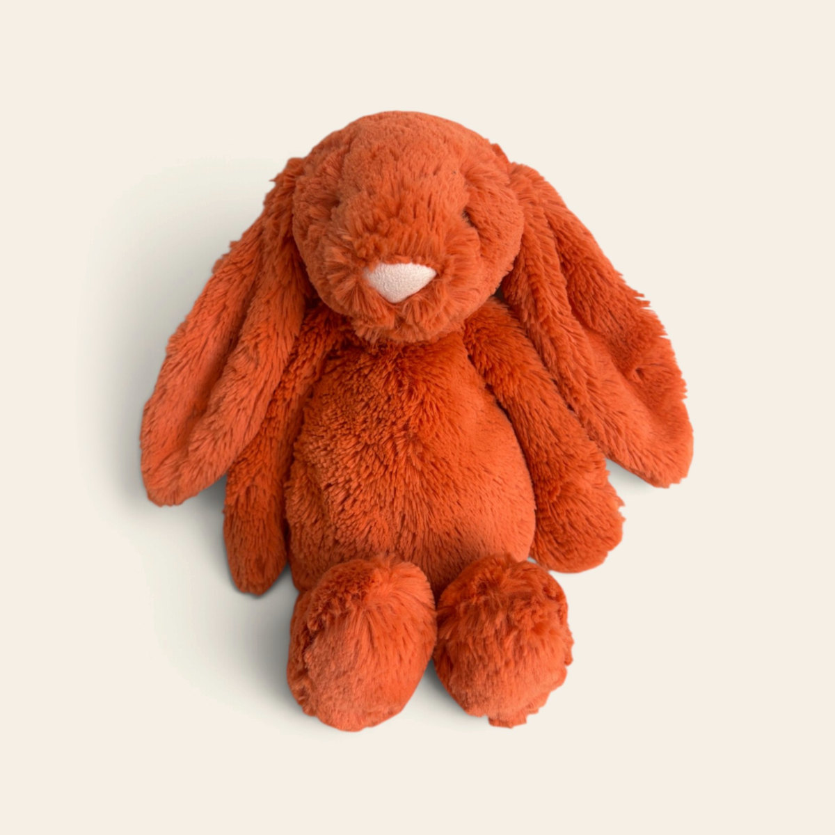 Bashful Tangerine Bunny BAS3BTA: a bright orange plush bunny with long floppy ears and a pink nose, sitting