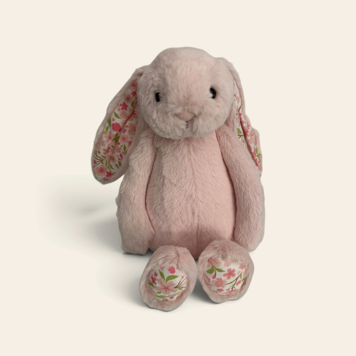 Blossom Blush Bunny BL3BLU: a dusky pink plush bunny with floral patterned inner ears and feet, sitting