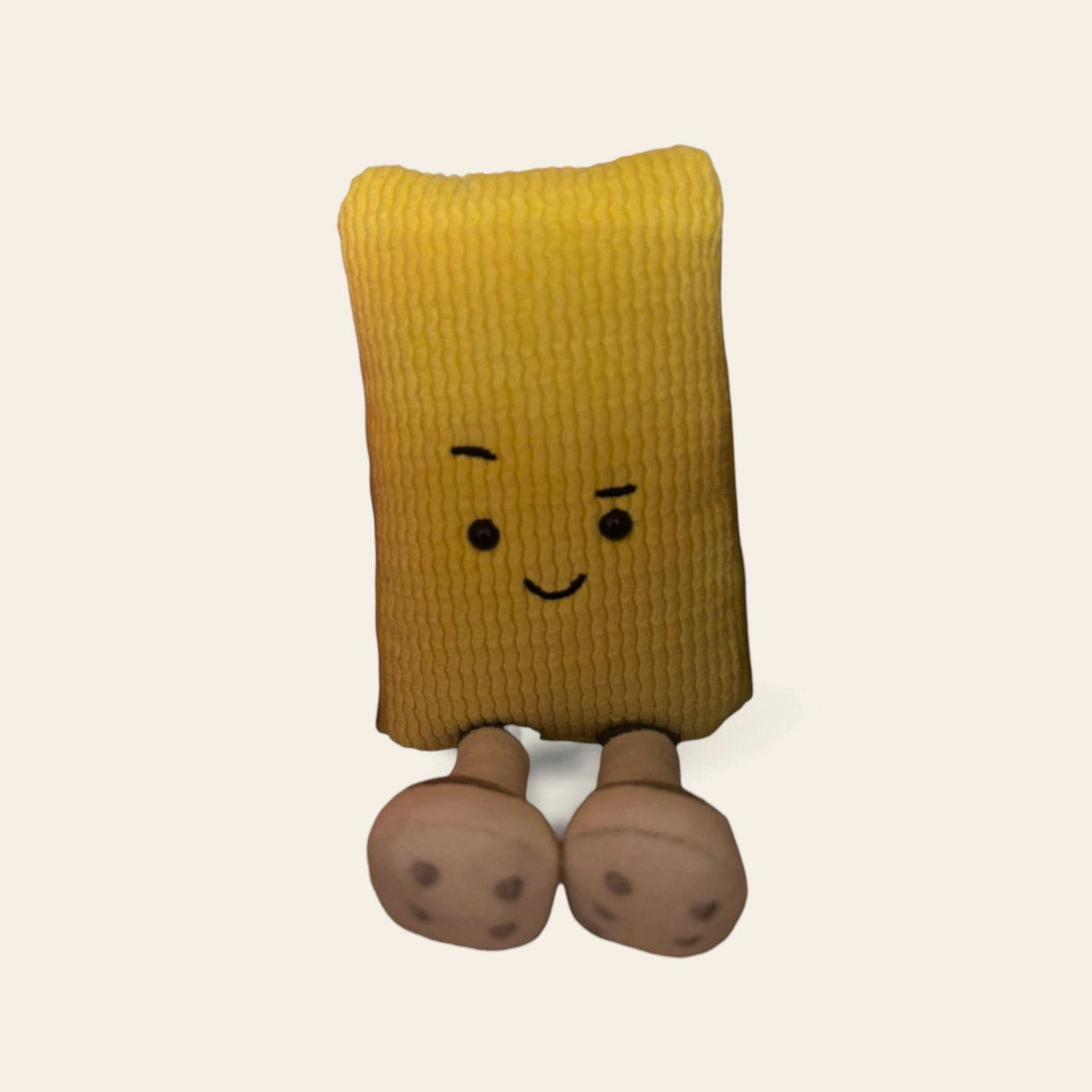 Amuseables Cracker A6CRA: a golden yellow plush cracker toy with a winking face and large brown feet