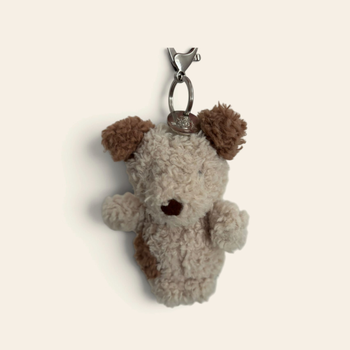 Little Pup Bag Charm L4PUBC: a small fluffy cream plush puppy with brown ears and a brown nose on a metal clip