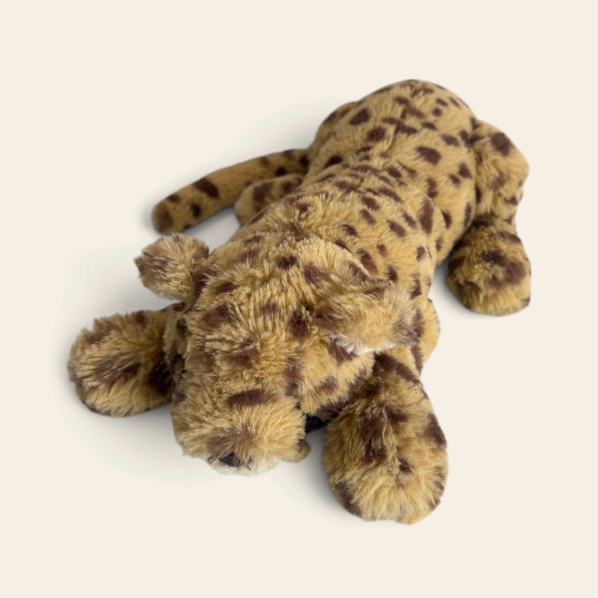 Livi Leopard LIV1L: a golden plush leopard with dark brown spots, lying down