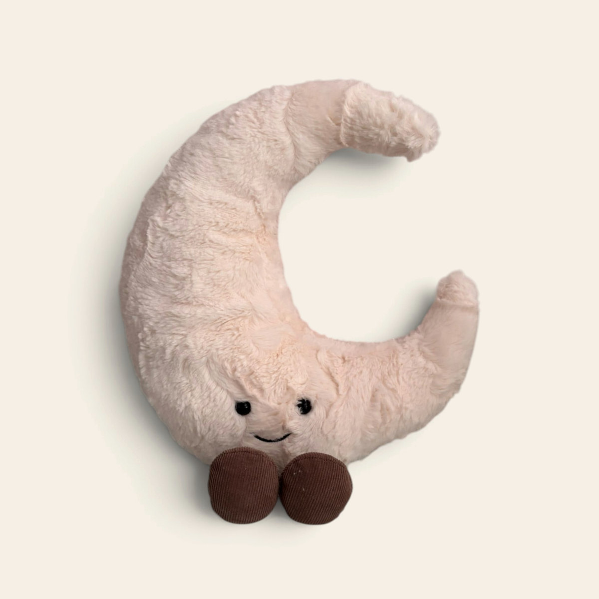 Amuseables Moon A2MOON: a cream crescent moon plush toy with a smiling face and brown legs