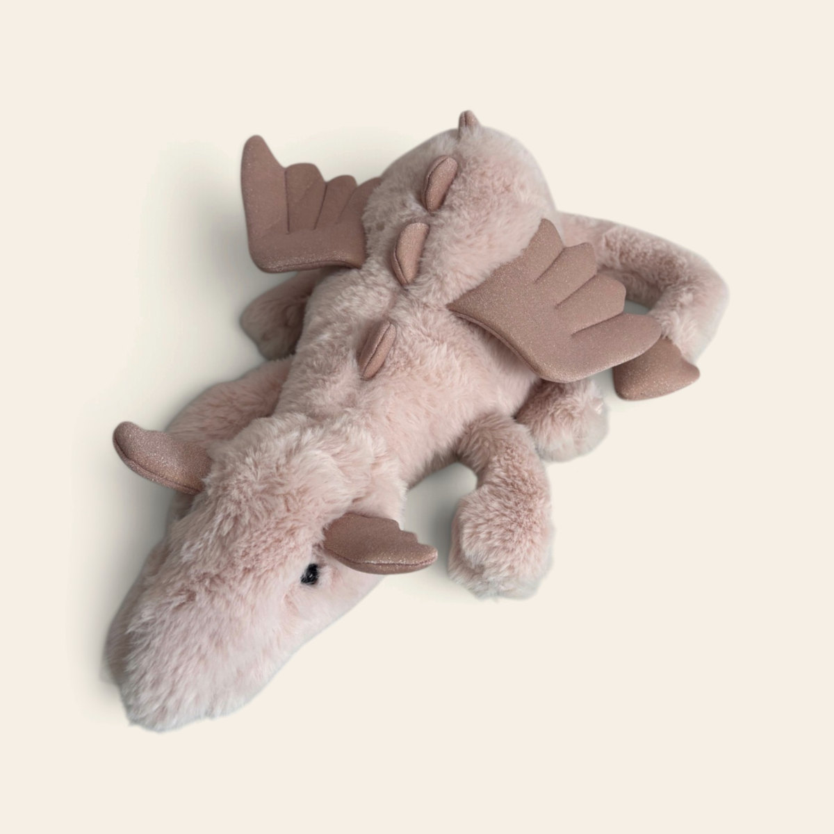 Rose Dragon ROSE2DD: a dusky pink plush dragon with soft wings and spines, lying down