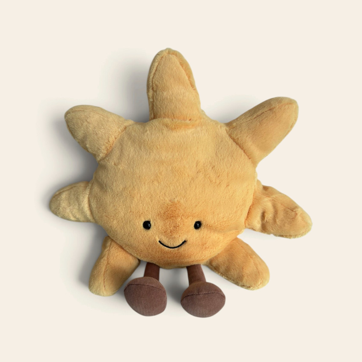 Amuseables Sun A2SUN: a yellow plush sun toy with soft pointed rays, a smiling face and brown corduroy legs