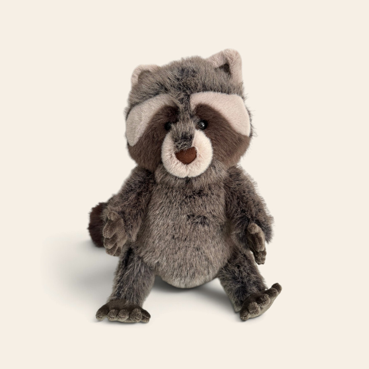 Trixiwoo Raccoon RA3CN: a grey-brown fluffy plush raccoon with a dark brown eye mask, cream face markings, a brown nose and a bushy tail, sitting